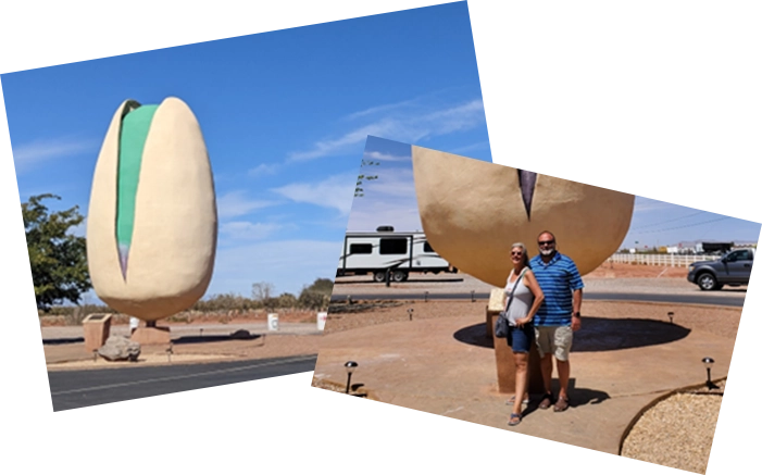 A couple standing in front of some giant balloons.